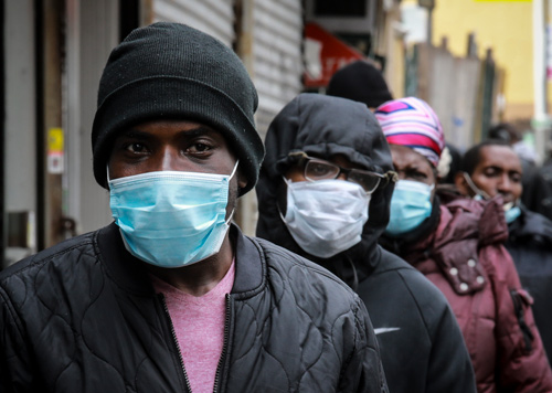 Group of men outdoors wearing surgical masks