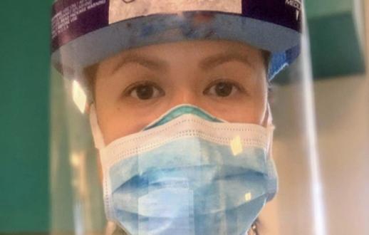 Asian American woman wearing face mask and shield