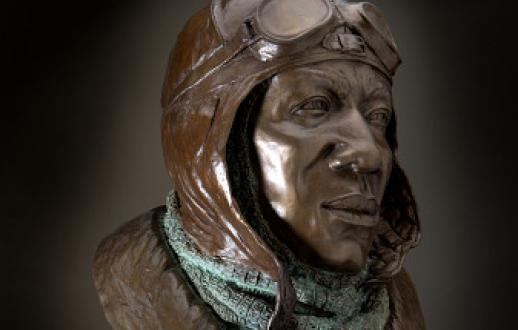 bronze bust of a man wearing combat attire of a pilot