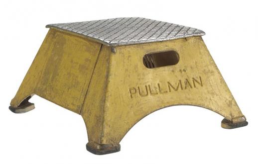A yellow, metal step stool with an unpainted metal crosshatched top and PULLMAN imprint.