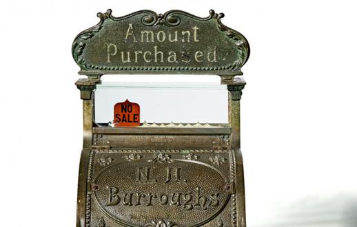 cash register with ornate brass exterior with a marble plate above the cash drawer