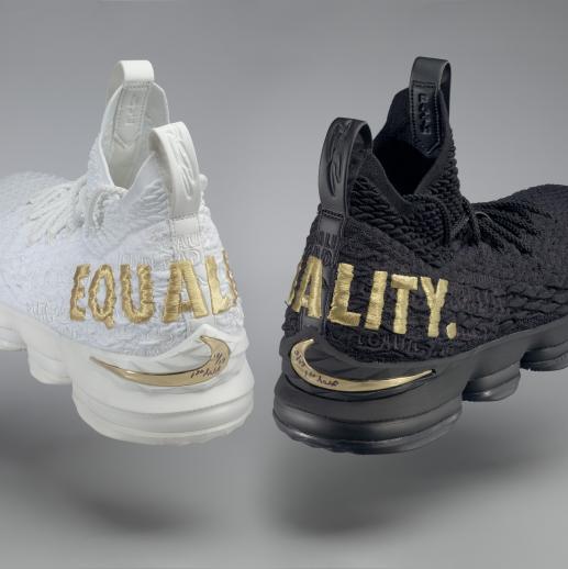 A pair of Nike ZOOM + MAX Equality basketball shoes game-worn by LeBron James. The shoes are made from synthetic fabric upper and other manmade materials. The left shoe is all white, and the right is entirely black.