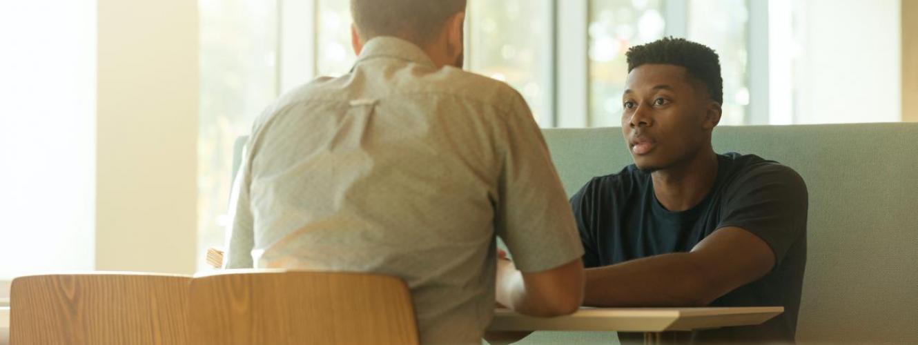 Two men having a discussion at a table